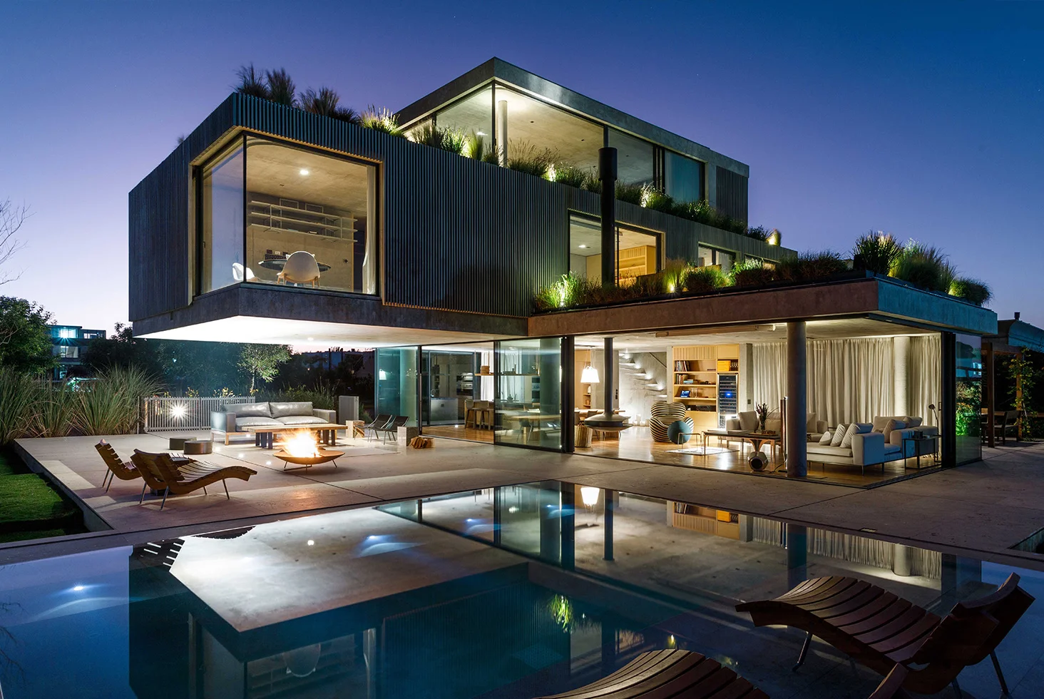 Nordelta residential luxury house with pool, terraces, and night lighting.